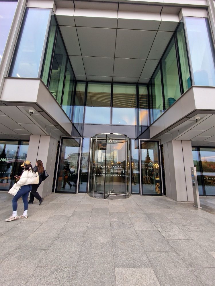 The riverside entrance to Sea Containers, a single revolving door set in glass